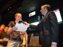 ARISS International Chair Frank Bauer, KA3HDO, holds the mic for a student at Seabrook Middle School during an ARISS contact at the Space Exploration Educators Conference in Houston last February.